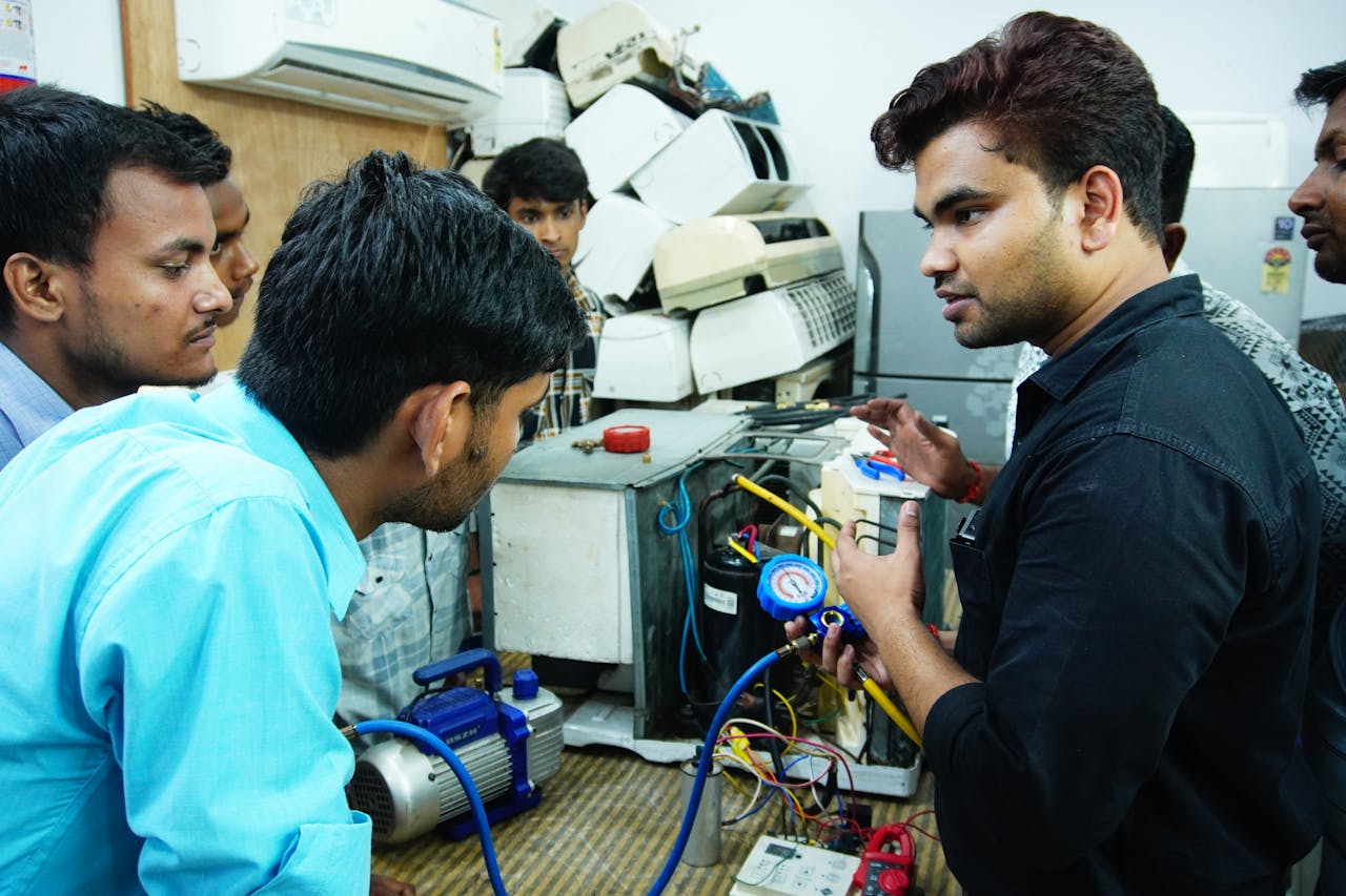 hero-img-02 Participants learn AC repair during a hands-on session in Delhi, India.